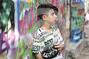 Boy portrait with grafiti behind photo