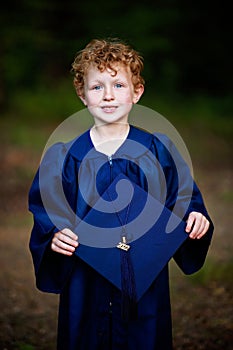 Boy posing for kindergarten graduation