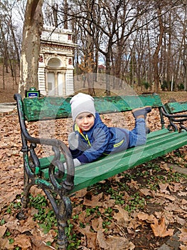 Boy posing on a parc bench