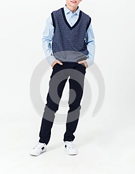 Boy posing in school uniform on white background.