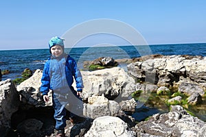 Boy posing on shore of black sea