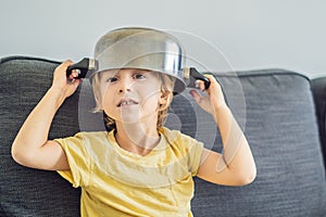 A boy with a pot on his head. Childhood, cook