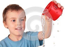 Boy pours out water