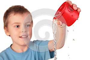 Boy pours out water photo