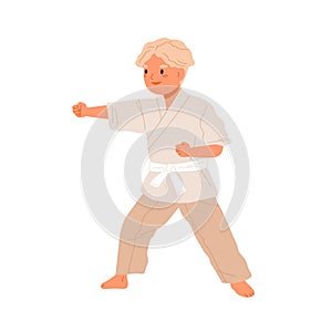 Boy practicing karate. Cute kid doing taekwondo exercises. Child training in kimono with white belt. Junior sports