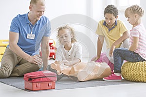 Boy practicing reanimation on manikin