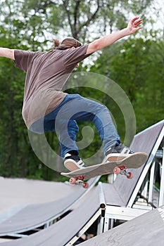 Boy practise in skatepark photo