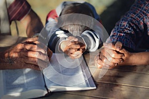 The boy prayed on the table