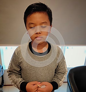 boy prays while standing