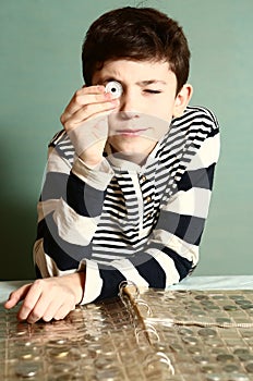 Boy preteen numismatic collector show his coin photo