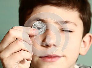 Boy preteen numismatic collector show his coin photo