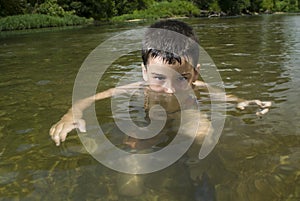 Boy pretends in creek