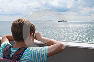 Boy pretends that looking through binoculars