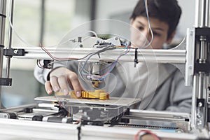 Boy printing a prototype using a 3D printer