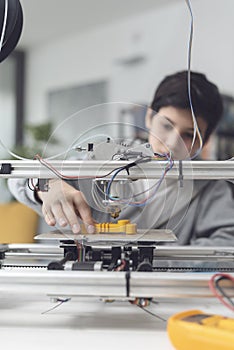 Boy printing a prototype using a 3D printer