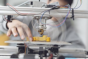 Boy printing a prototype using a 3D printer