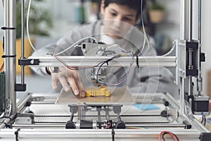 Boy printing a prototype using a 3D printer