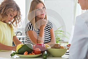 Boy and professional dietitian preparing a diet eating plan