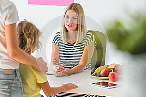 Boy and professional dietitian preparing a diet eating plan