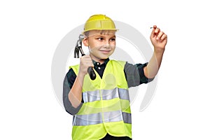boy in protective helmet with hammer nailing nail