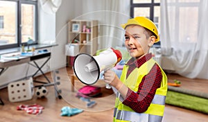 boy in protective helmet talking to megaphone