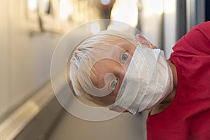 Boy in protective mask rides train compartment. Traveling during a quarantine