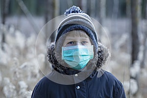 Boy in protective sterile medical mask on his face