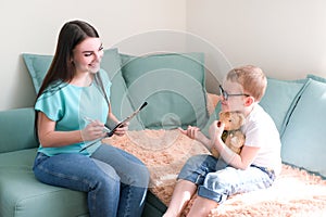 Boy in a psychologist`s office. Psychologist talking to a child