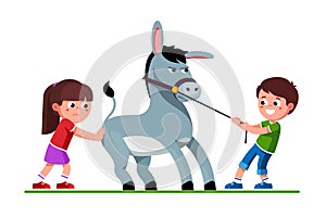 Boy pulling donkey on reins and girl pushing it