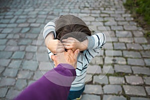 The boy is pulling his father`s hand.
