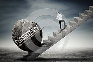 Boy pulling stone with persistence word