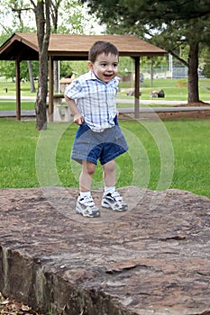 Boy Pulling Up Shorts At The Park