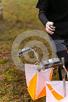 A boy punching at the orienteering control point