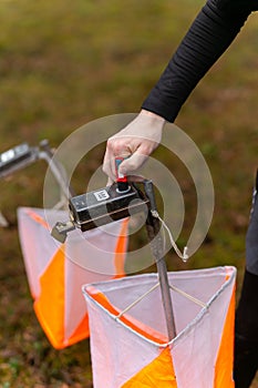 A boy punching at the orienteering control point