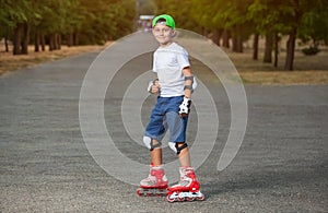 The boy put on protective knee pads and skates in the park