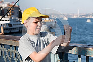 The boy puts the bait on the hook photo