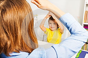 Boy putting hands together like therapist sitting photo