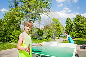 Boy with racket ready to serve table tennis ball