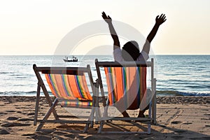 Boy raise two hand on the beach