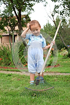 Boy raking in the garden