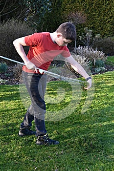 Boy raking up grass