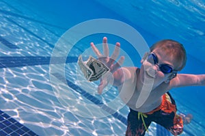 Boy reaching dollar bill