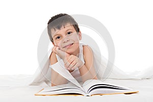 Boy read a book in bed