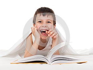 Boy read book in bed