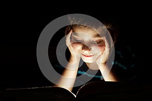 Boy reading bedtime story photo