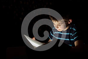 Boy reading bedtime story photo