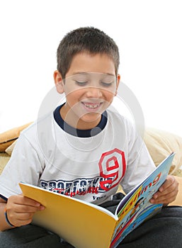 Boy reading a book on the floor