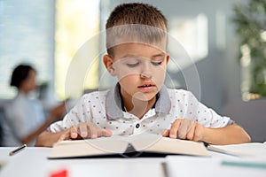 Boy reading book at home