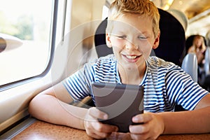 Boy Reading A Book On Train Journey