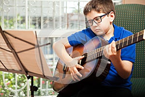 Boy reading a guitar sheet music